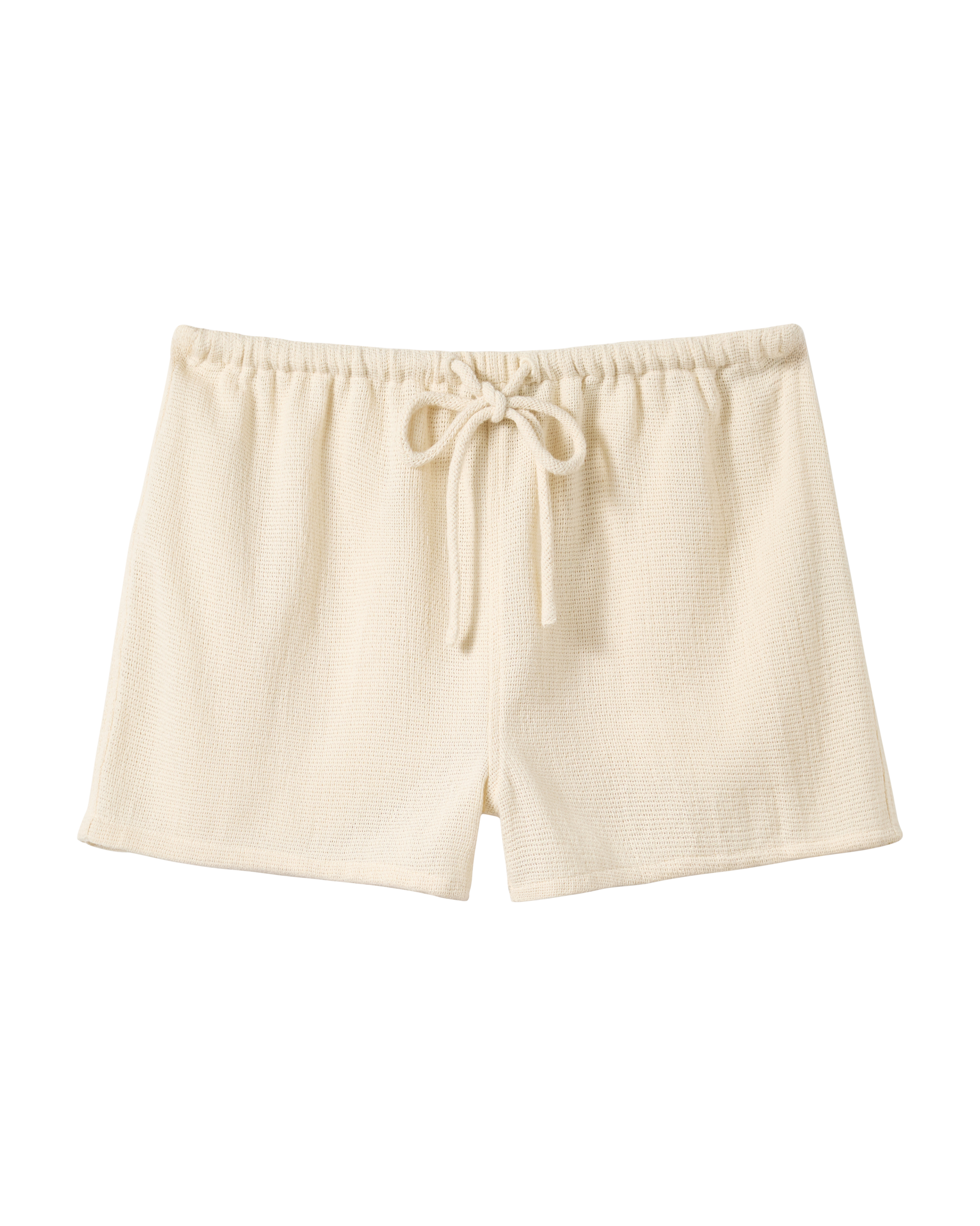 The Sevilla Short - Scallop by Dandy Del Mar, cream-colored and textured with an elastic waistband and front drawstring, shown on a plain black background.