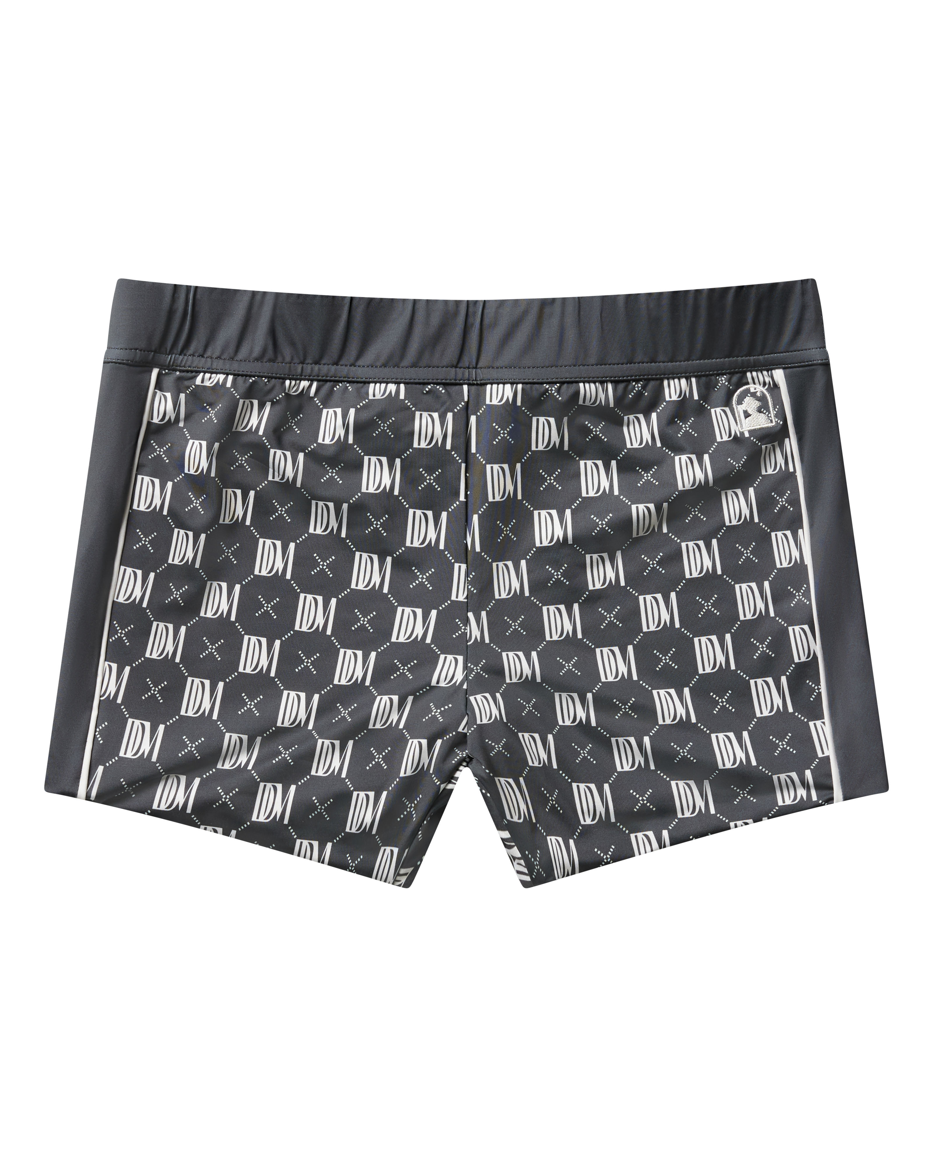 The Cassis Square Cut Swim Brief - DDM Monogram by Dandy Del Mar features a white monogram pattern on black recycled polyester, with a modern European fit, fitted waistband, and side panels—shown against a plain black background.