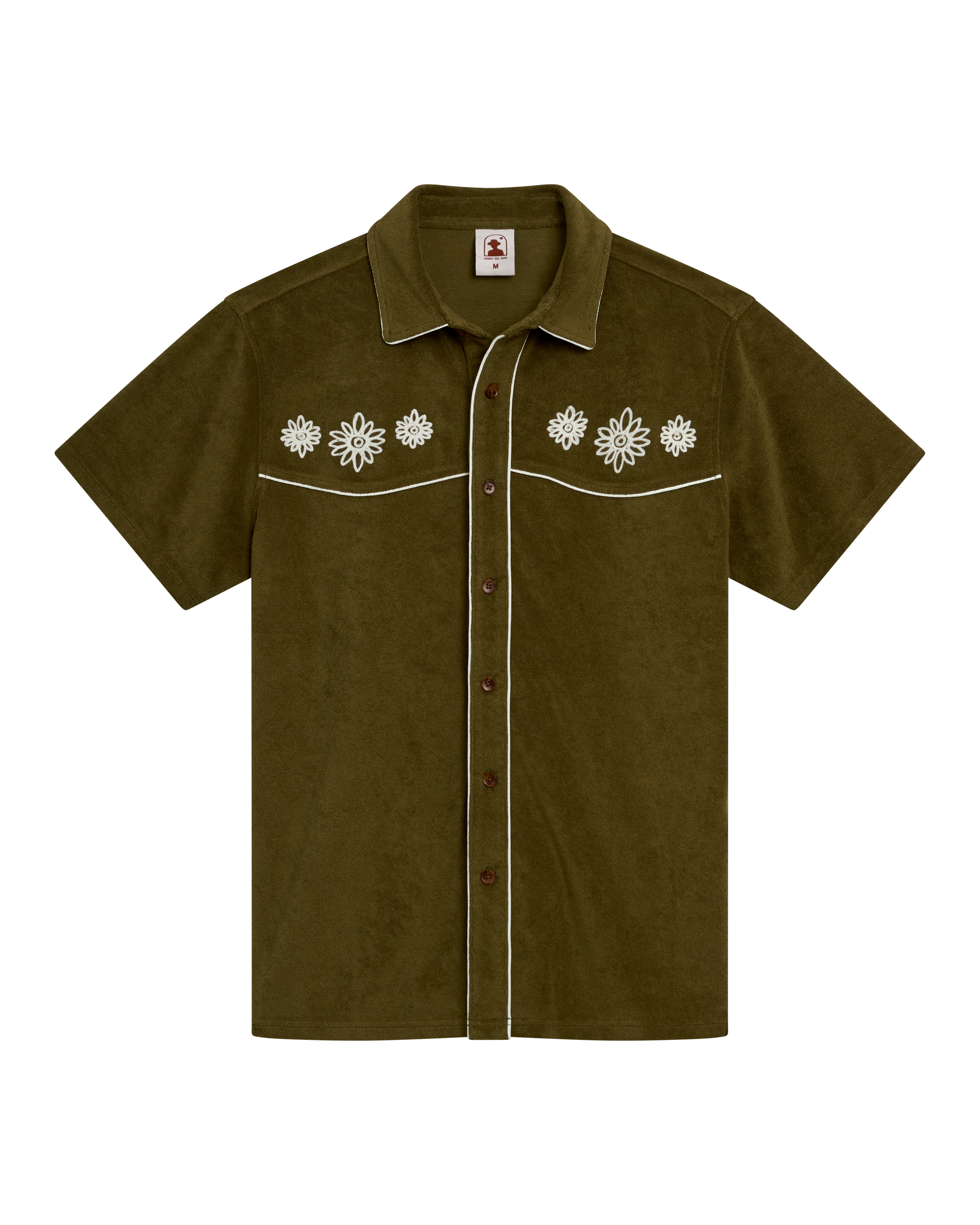 The Gaucho Shirt - Arbequina by Dandy Del Mar features short sleeves, olive green fabric, white floral chest embroidery, and white piping on seams and pockets—ideal for an Equatorial Cowboy style.