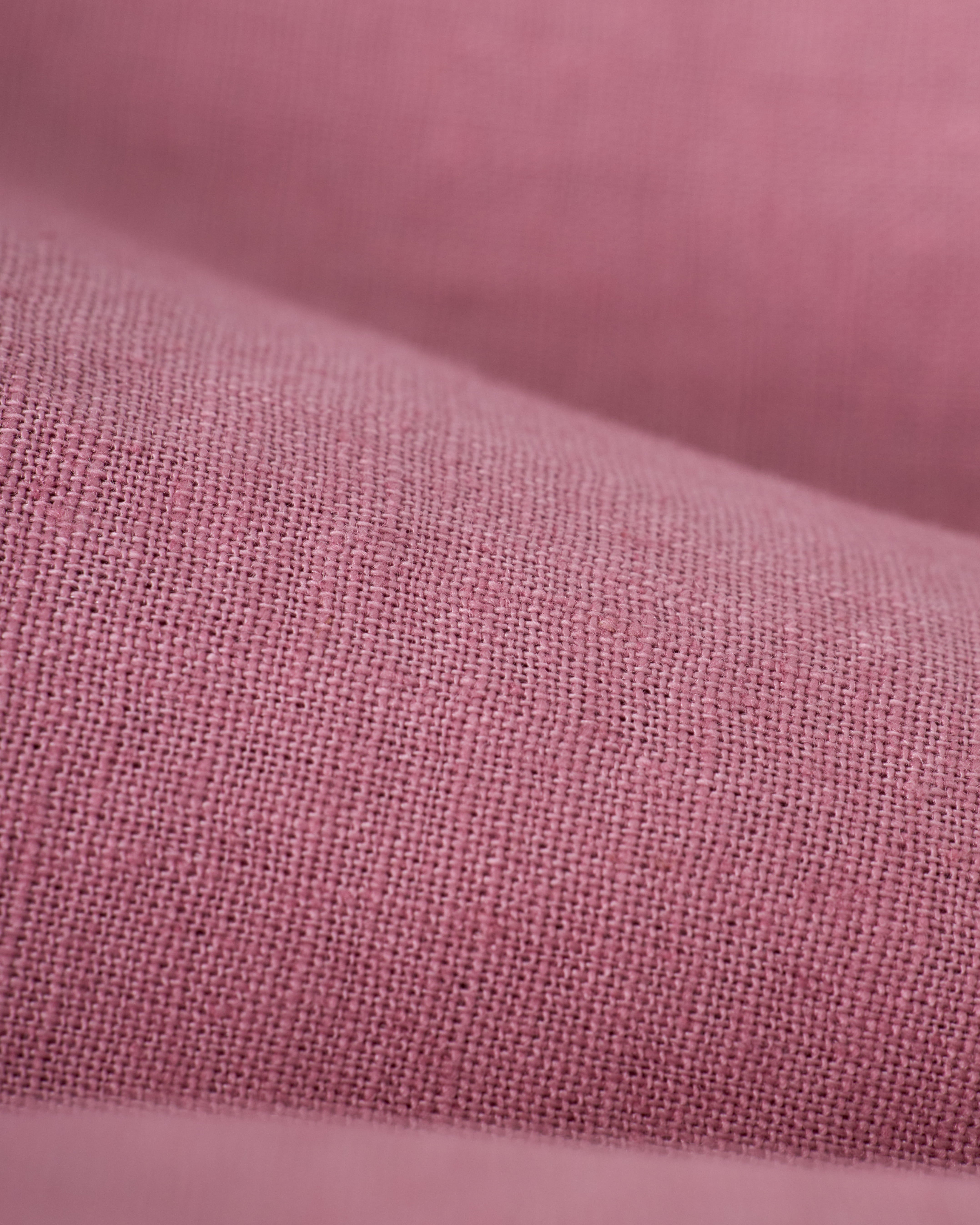 Close-up of Dawn pink fabric with smooth texture and a slight weave pattern, reminiscent of The Brisa Linen Pant by Dandy Del Mar, ideal for vacation pants.