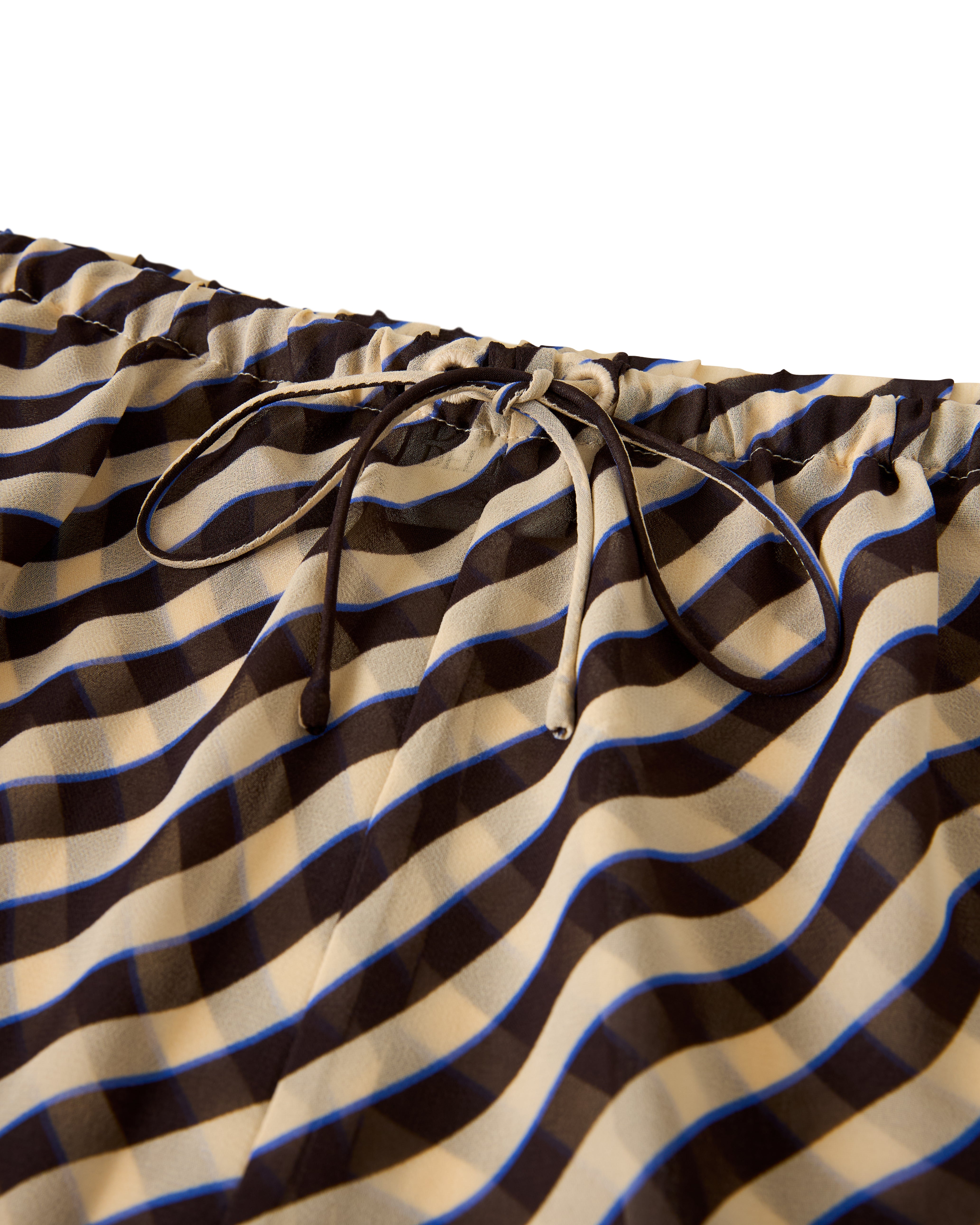 Close-up of the Dandy Del Mar "The Curacao Short - Tierra," featuring a brown, beige, and blue wavy-striped fabric with a drawstring.