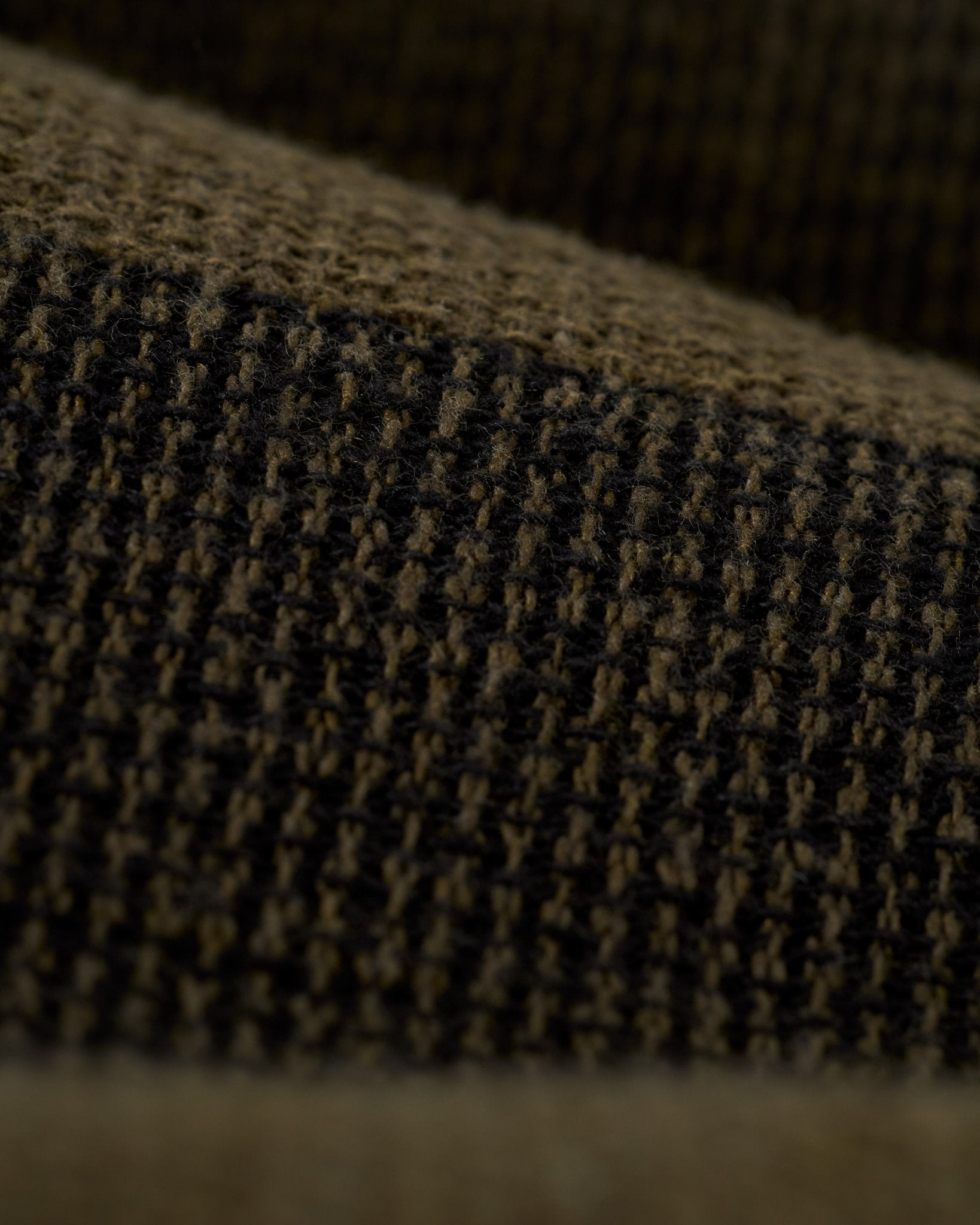 Close-up of The Palma Shorts - Onyx by Dandy Del Mar, showcasing a textured brown and black yarn-dyed stripe canvas with a grid-like woven pattern.