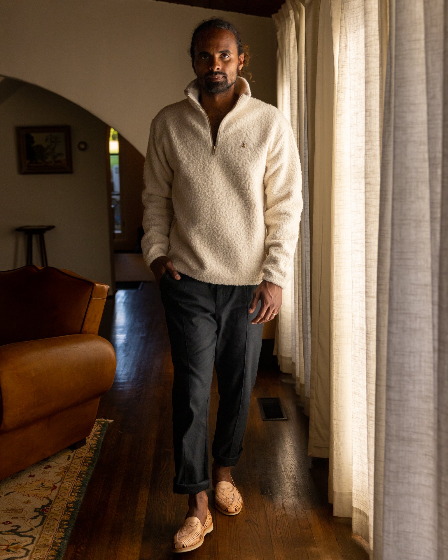 man waling by living room windows in Cusco Sherpa Pullover