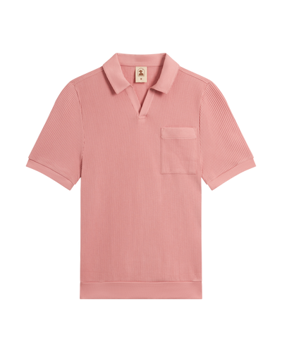 The Cannes Waffle Knit Polo Shirt - Spanish Rose by Dandy Del Mar, a short-sleeve polo with chest pocket and open collar in light pink waffle knit, is laid flat on a white background.