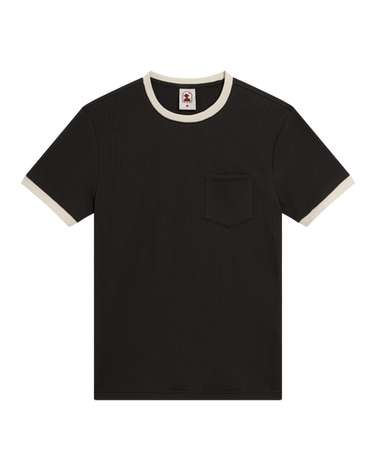 The Dandy Del Mar Cannes Waffle Knit Tee - Albatross features black short sleeves, a white contrast collar and cuffs, ribbed waffle knit texture, and a small chest pocket.