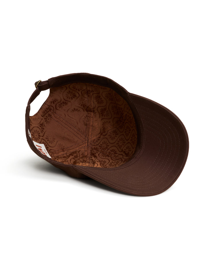 A Dandy Del Mar baseball cap - The Dandy Icon Hat Carajillo, with a jacquard lining on a white background.