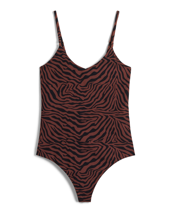 Dandy Del Mar's The Deia One Piece - Onyx is a brown and black zebra-striped swimsuit with thin shoulder straps and a high-cut cheeky design, perfect for women's swimwear.