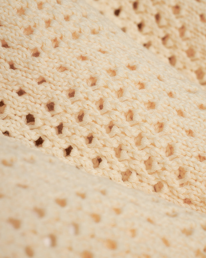A close up of the Antibes Crochet Shirt - Vintage Ivory from Dandy Del Mar.