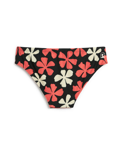 Explore Dandy Del Mar's Belize Swim Briefs in Currant, featuring a black base with a red and white floral design. Made from recycled polyester, they perfectly blend style and sustainability for the modern epicurean.