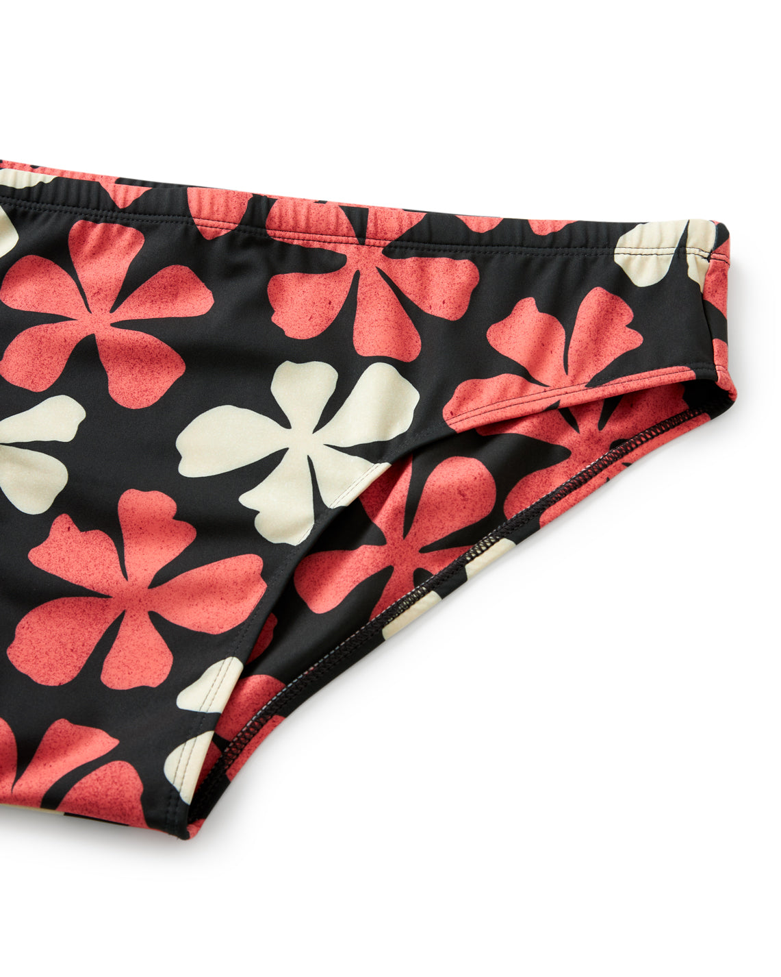 A close-up of The Belize Swim Briefs - Currant by Dandy Del Mar displays red and white floral patterns on black. Made from recycled polyester, it embodies an epicurean lifestyle, blending style with sustainability.