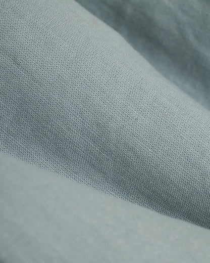 A close up of a blue Dandy Del Mar Brisa Linen Pant - Abalone, an elastic waist pant ideal for vacation.