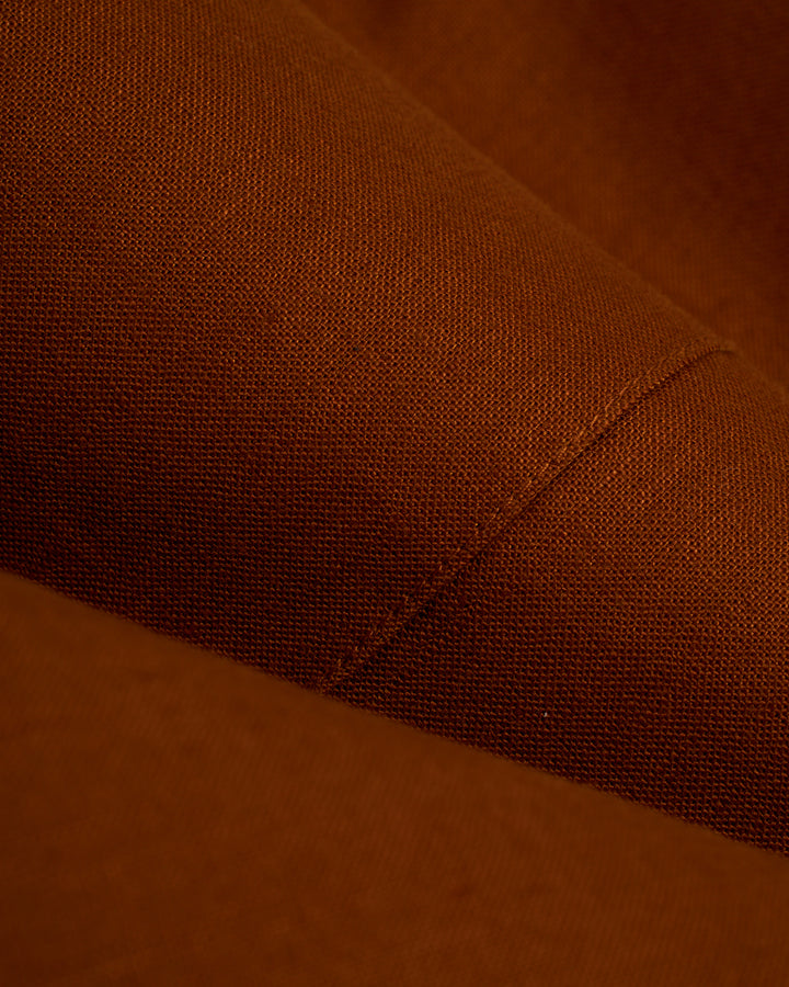 A close up of a brown fabric, featuring the Dandy Del Mar Brisa Linen Blazer - Sedona.