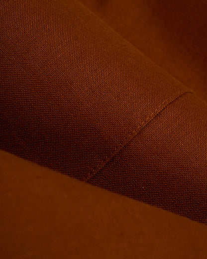 A close up of a brown fabric, featuring the Dandy Del Mar Brisa Linen Blazer - Sedona.