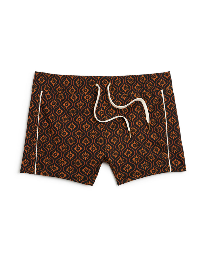 A Dandy Del Mar Cassis Square Cut Swim Brief - Cacao featuring a geometric pattern in brown and black.