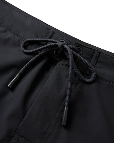 Close-up of The Cavoli Swim Shorts - Onyx by Dandy Del Mar, featuring a black drawstring waistband with black grommets, crafted from performance fabric with detailed stitching.