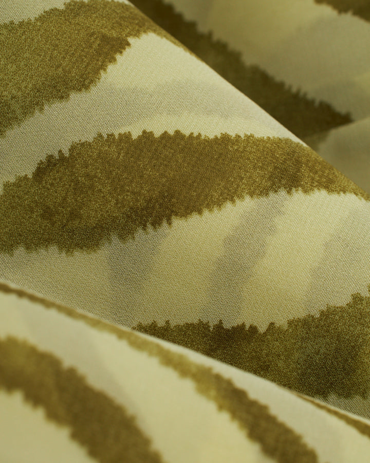 A close up of the Cayman Pants - Arbequina by Dandy Del Mar zebra print fabric.
