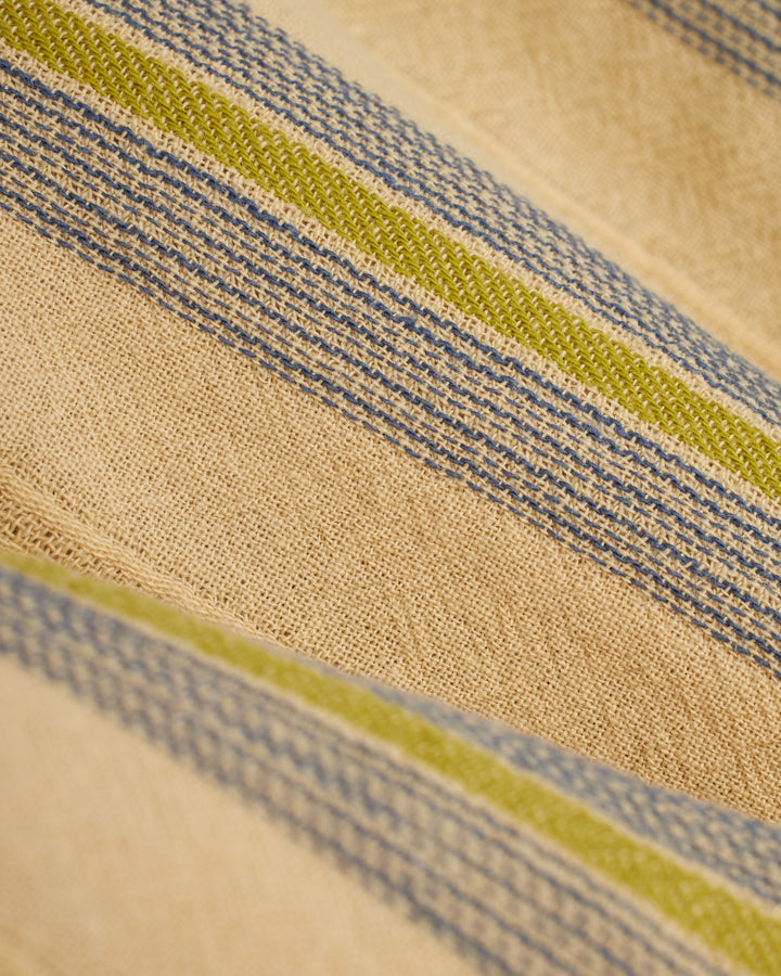 A close up of The Corralejo Short - Ginger from Dandy Del Mar, a beige and blue striped cloth.