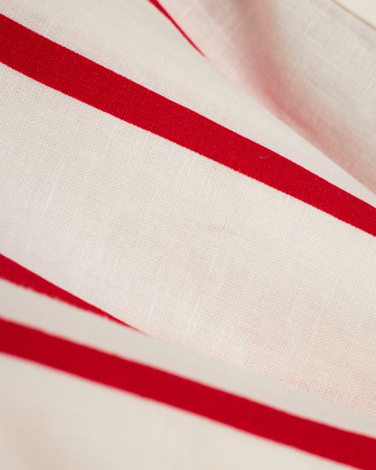 A close up of The Crete Linen Shirt - Pico by Dandy Del Mar, a red and white striped fabric.