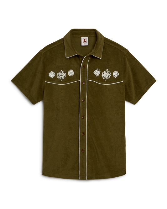 A green Gaucho Shirt - Arbequina with white flowers on it from Dandy Del Mar.