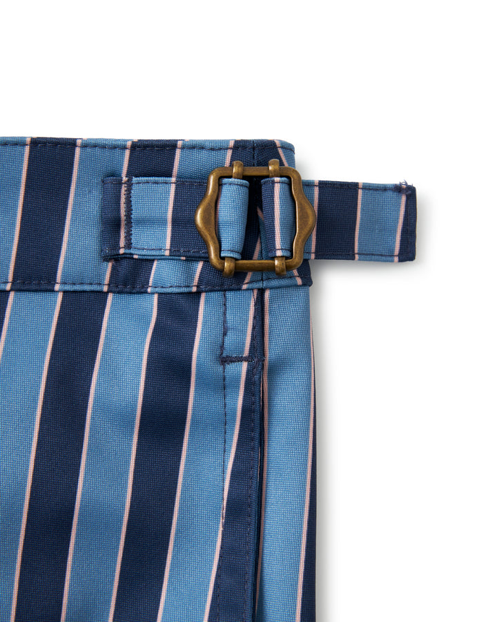 A blue and pink striped Mallorca Swim-Walk Short by Dandy Del Mar with adjustable antique brass side fasteners.