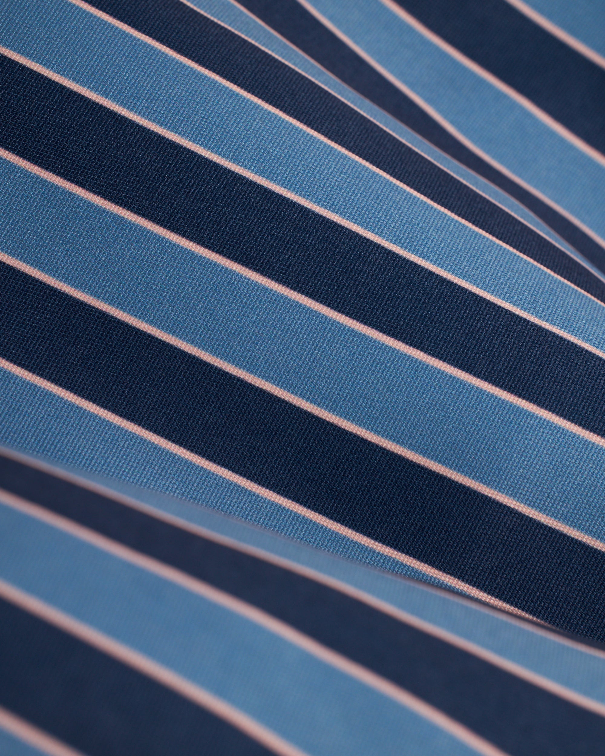 A close up of a blue and pink striped shirt with Mallorca Swim-Walk Short design by Dandy Del Mar.