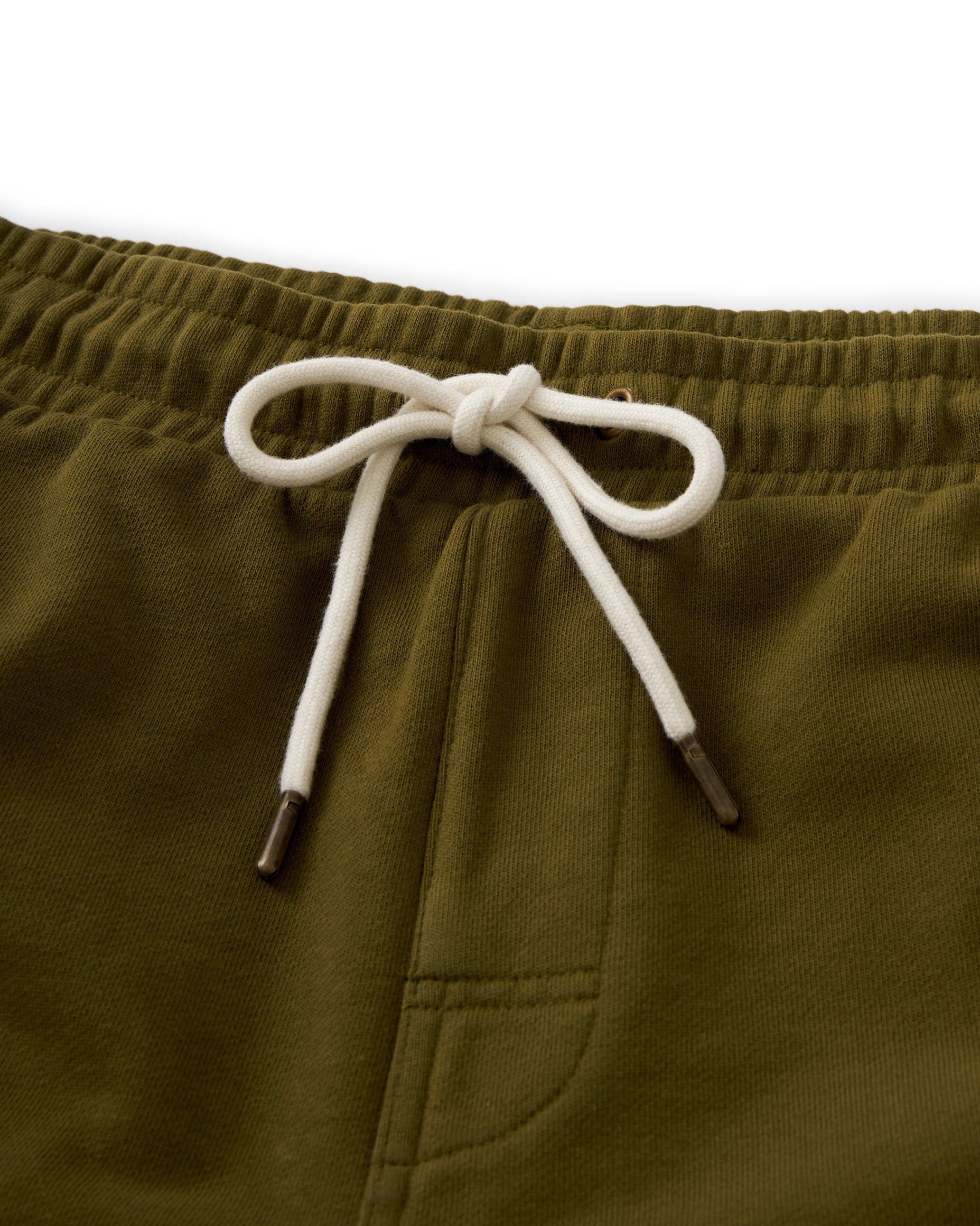 Close-up of the waistband of the olive green Dandy Del Mar Marseille French Terry Short in Arbequina, featuring a white drawstring tied in a bow.