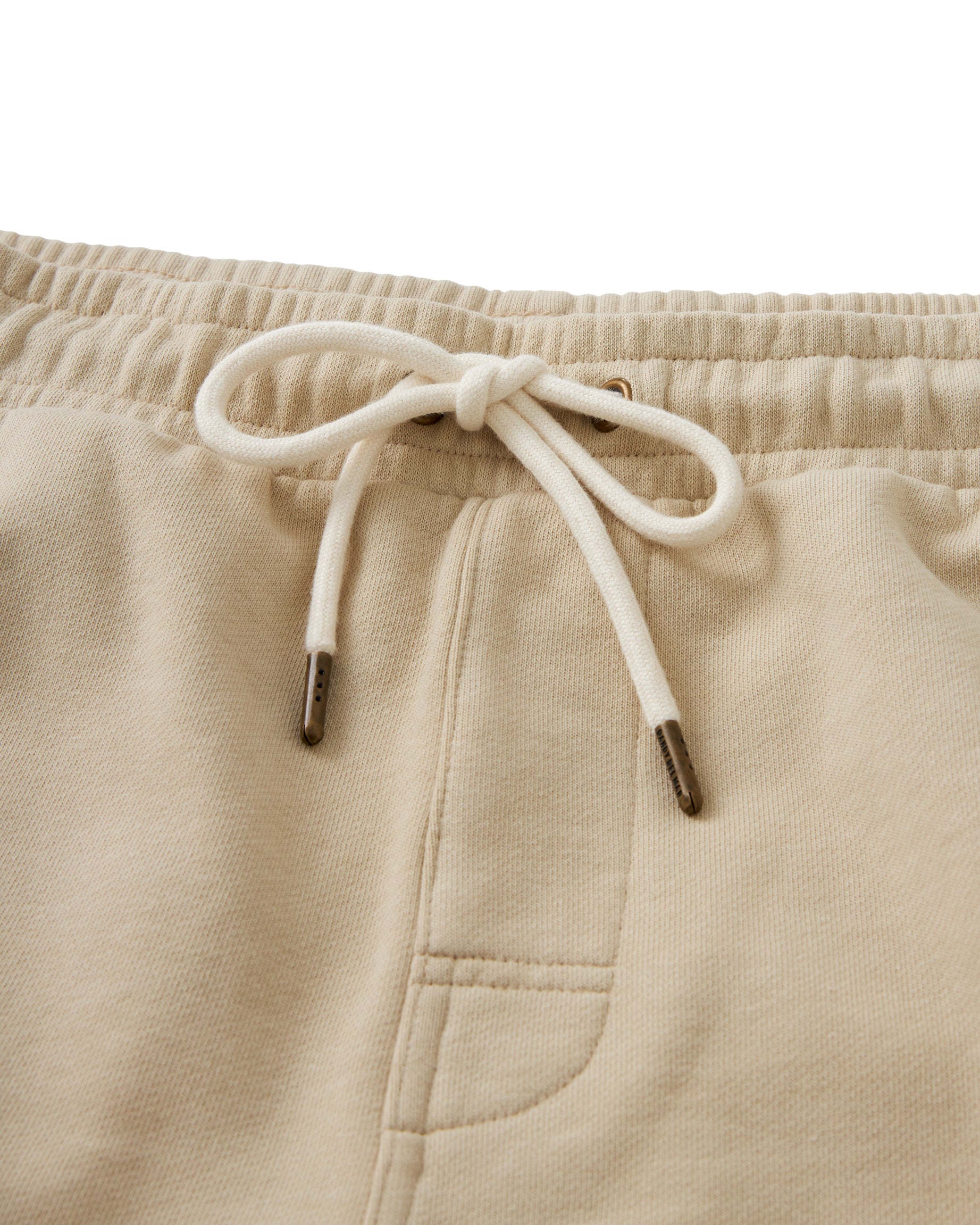 Close-up of The Marseille French Terry Short - Ginger from Dandy Del Mar, showcasing an elastic waistband with a white drawstring tie and a front pocket, crafted from soft French terry.