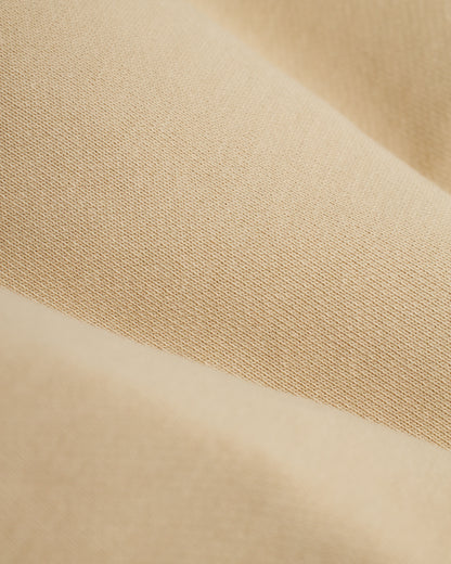 Close-up of ginger fabric with a slightly ribbed texture and subtle color variations, reminiscent of The Marseille French Terry Short - Ginger by Dandy Del Mar.