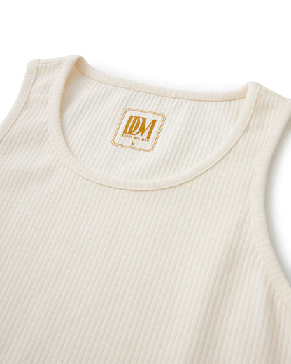 A Dandy Del Mar Milan Rib Tank - Shell with a gold logo on it.