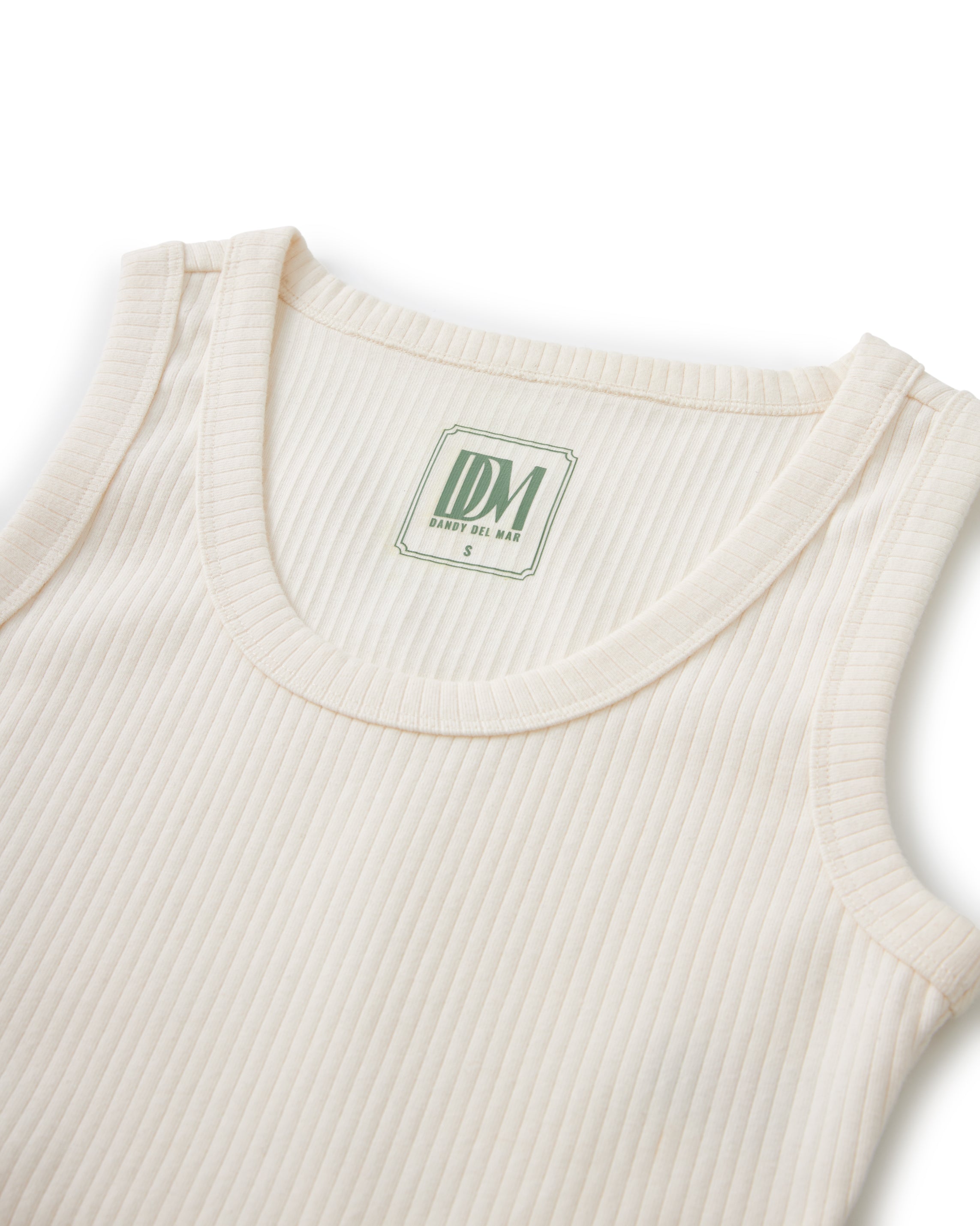 A Dandy Del Mar Seine Rib Tank - Shell with a green label on it.