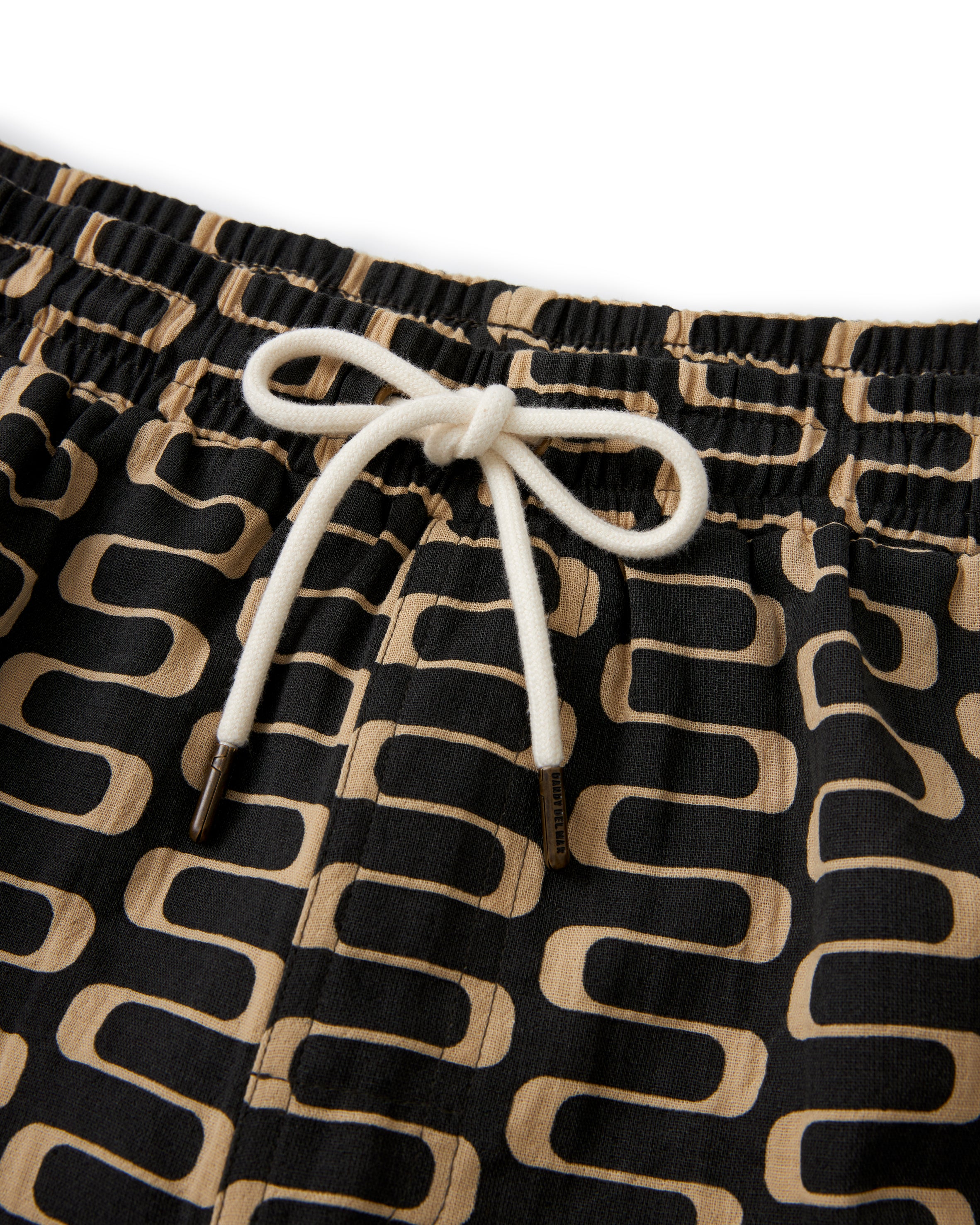 A Dandy Del Mar Grenadine Short - Truffle with a geometric pattern.