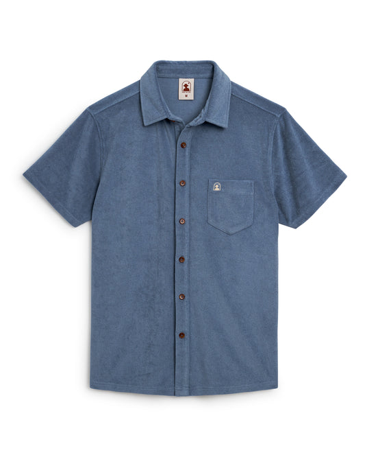 The Tropez Terry Cloth Shirt - Annapolis by Dandy Del Mar is a light blue short-sleeve button-up made from premium terry cloth, featuring a chest pocket. Displayed against a plain white background, it evokes the elegance of Côte d'Azur.