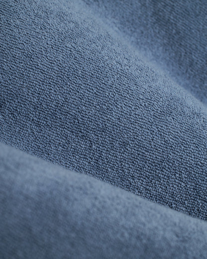 Close-up of The Tropez Shirt - Annapolis by Dandy Del Mar, showcasing its blue textured fabric made from premium terry cloth with small loops and a soft surface.