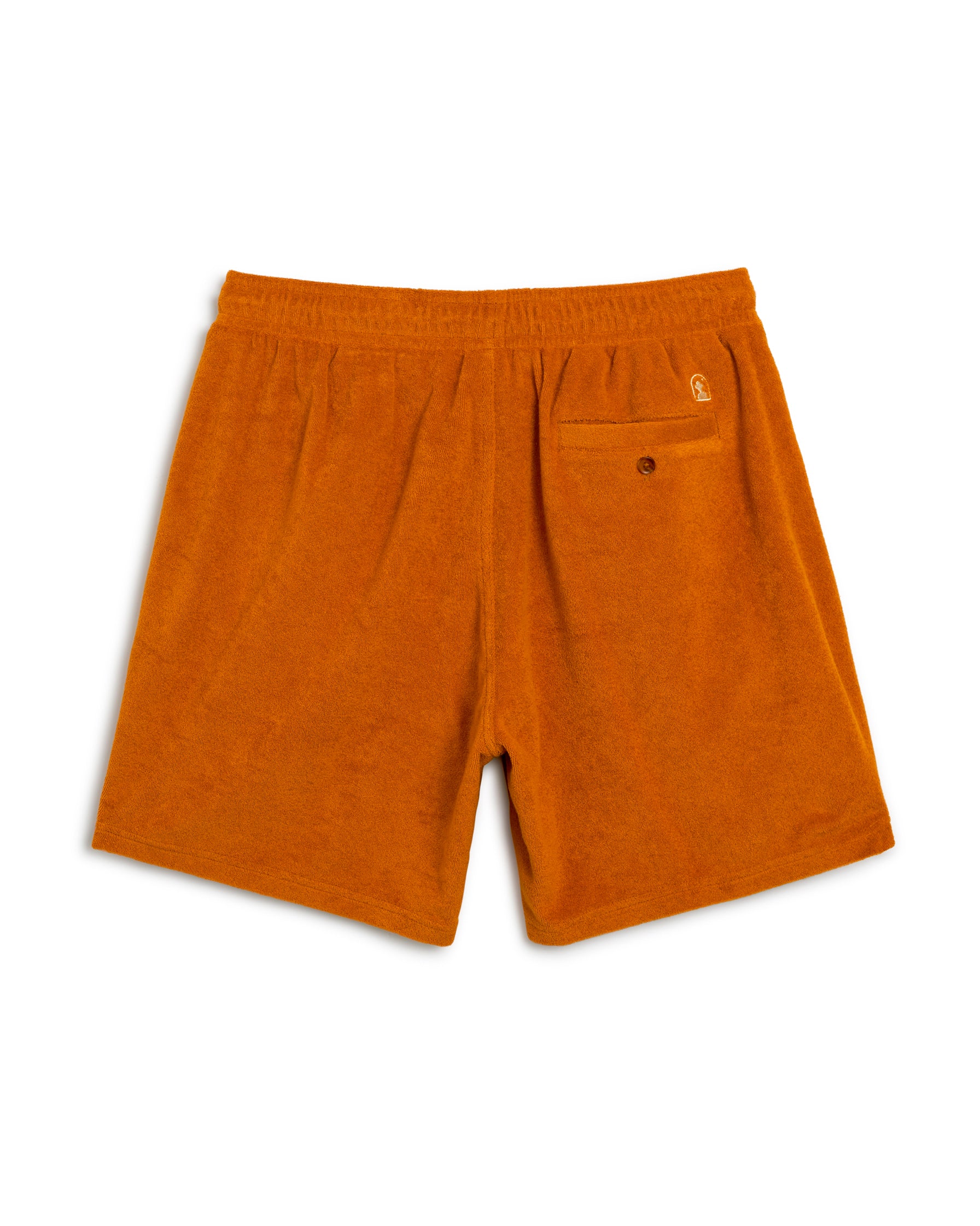 The Tropez Short in Burnt Sienna by Dandy Del Mar features an elastic waistband, side pockets, and a chic buttoned back pocket with Côte d'Azur-inspired terry cloth design.