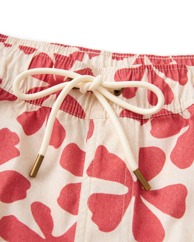 Close-up of a cream drawstring with brass tips on The Ventura Volley Shorts - Currant by Dandy Del Mar, featuring a beige base and red floral print—perfect for stylish men's swimwear.