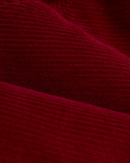 Close-up view of Italian corduroy fabric, showcased in the Dandy Del Mar Corsica Corduroy Jacket - Sangria, highlighting its rich, textured, ribbed surface.