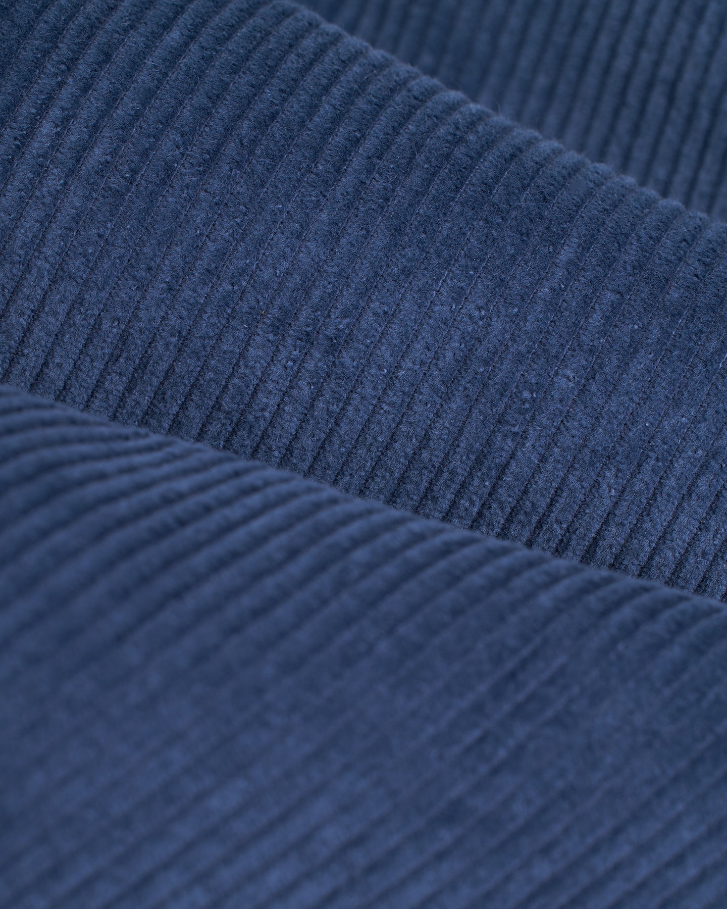 Close-up of folded Moontide 8-wale corduroy fabric from Dandy Del Mar's Corsica Corduroy Shirt, showcasing the ribbed texture and soft material typical of a tailored relaxed fit.