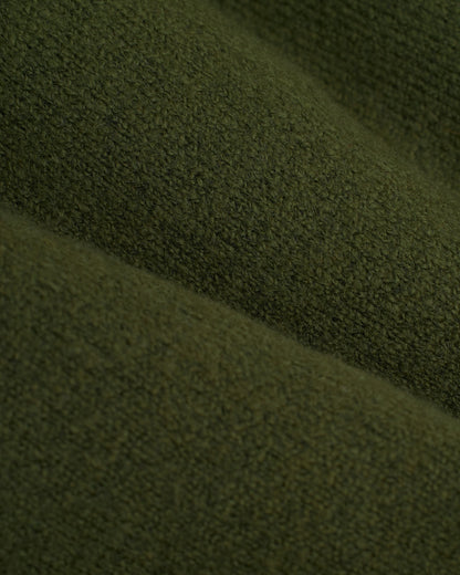 A close up of the Lima Sweater - Selva by Dandy Del Mar, an olive green sweater.