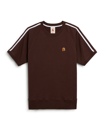 The Marseille French Terry Pullover in Carajillo by Dandy Del Mar is a brown short-sleeve sweatshirt featuring white stripes along the shoulders, a ribbed neckband, and a small embroidered logo on the left chest.