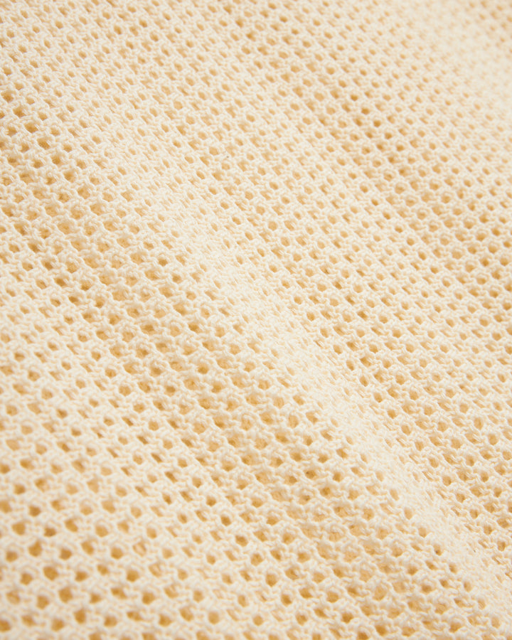 Close-up of a Vintage Ivory Dominica Crochet Tank by Dandy Del Mar with a waffle weave pattern.
