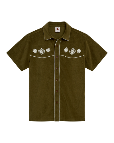 The Gaucho Terry Cloth Shirt - Arbequina by Dandy Del Mar features short sleeves, olive green color, white piping, floral embroidery on the chest, and two front chest pockets.