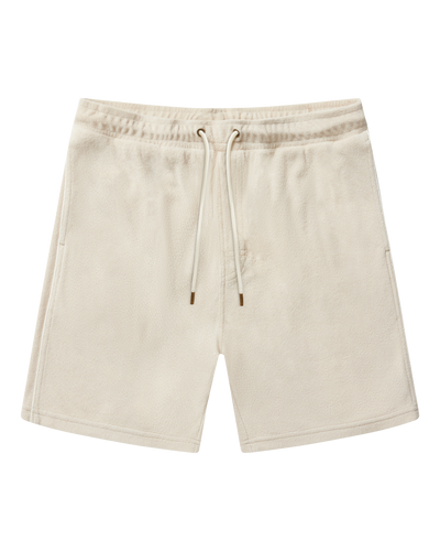 The Gaucho Terry Cloth Shorts in Alabaster by Dandy Del Mar feature an elastic waistband, drawstring, and side pockets—laid flat on white, they're perfect for a relaxed Equatorial Cowboy vibe.