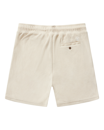 Back view of Dandy Del Mar’s The Gaucho Terry Cloth Shorts in Alabaster, featuring an elastic waistband and a single buttoned back pocket on the right side.