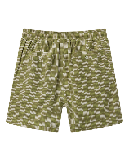 The Grenadine Crinkle Gauze Shorts - Berdea Palermo Print by Dandy Del Mar feature a green and beige check design, elastic waist, two buttoned back pockets, and crinkle gauze fabric, shown flat on a black background.