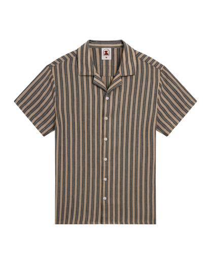 The Palma Shirt - Cacao Stripe by Dandy Del Mar is a relaxed-fit, short-sleeve button-up featuring beige and navy stripes, a notched collar, and white buttons—your go-to for effortless style.
