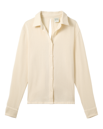 The Sevilla Top - Scallop by Dandy Del Mar is a cream, long-sleeved, collared button-up shirt shown flat on a black background.