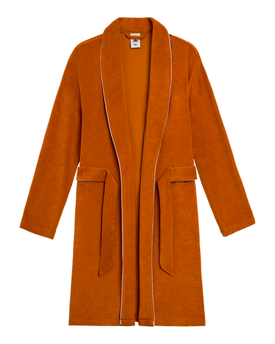 The Tropez Terry Cloth Robe in Burnt Sienna by Dandy Del Mar features ultra-soft fabric, a belt, shawl collar, long sleeves, and two front pockets, shown on a white background.