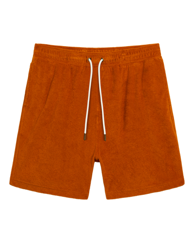 The Tropez Terry Cloth Shorts in Burnt Sienna by Dandy Del Mar, crafted from soft terry cloth with an elastic waistband and white drawstrings, are displayed on a plain white background.