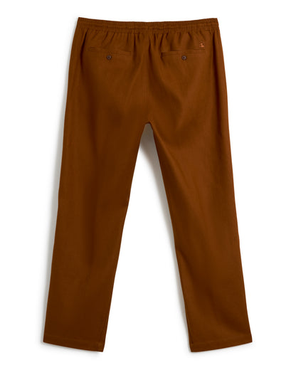 A pair of The Brisa Linen Pants in Sedona by Dandy Del Mar, featuring an elastic waistband and two back pockets.