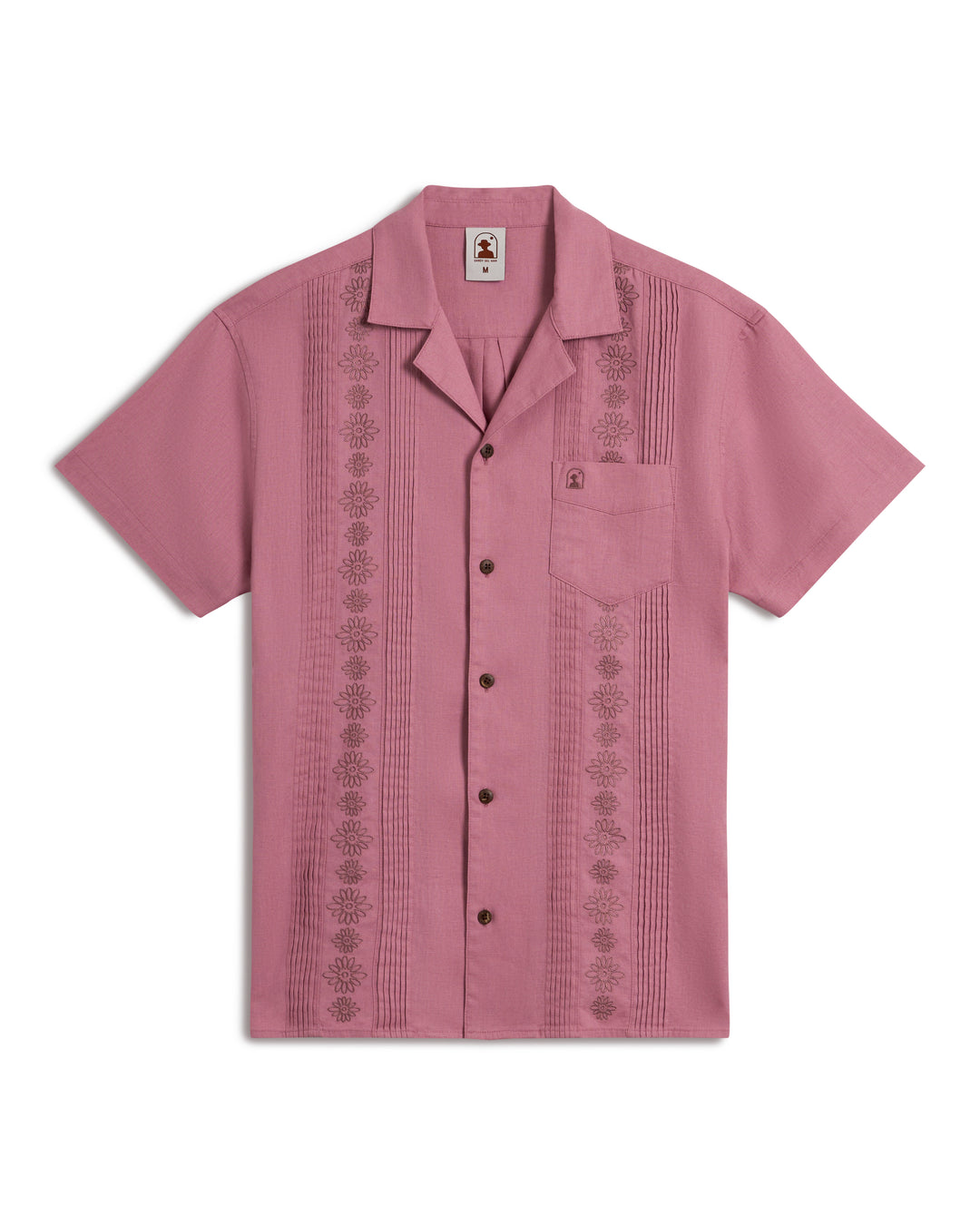 The Brisa Linen Shirt - Dawn by Dandy Del Mar is a pink short-sleeved guayabera with intricate vertical embroidery, a front pocket, and a button-down front.